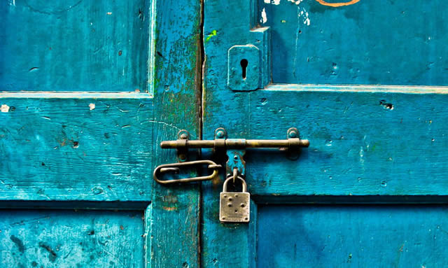 Синяя дверь запертая на засов и замок
